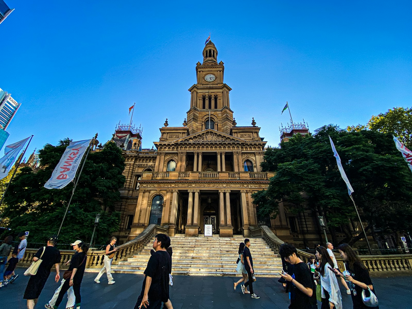 A group of people walking in front of a building